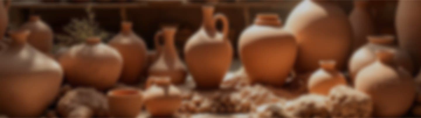 Rows of unglazed terracotta vessels drying in the studio
